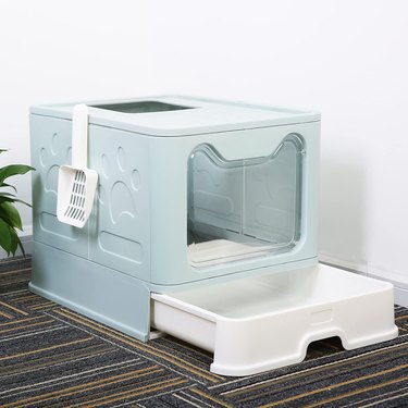 Baby blue top-entry cat litter box with a slide-out pan and a scoop that hangs off the side.